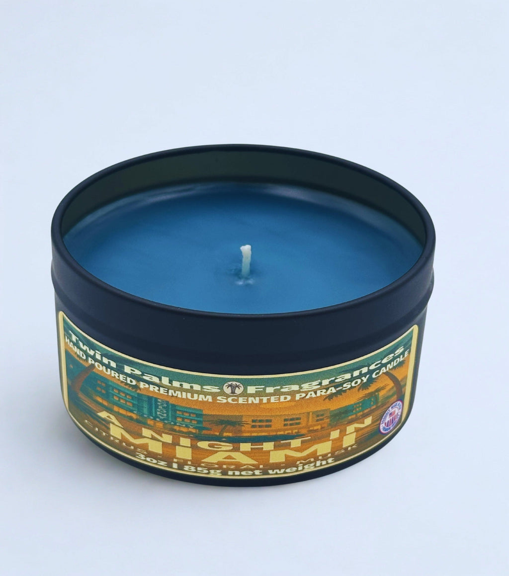 A NIGHT IN MIAMI Blue candle in a tin with a label on a light blue background