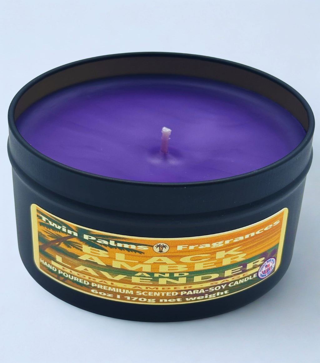 Purple candle in a black tin with a label on a light gray background