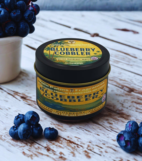 Tin of Blueberry Cobbler candle with blueberries on a wooden surface