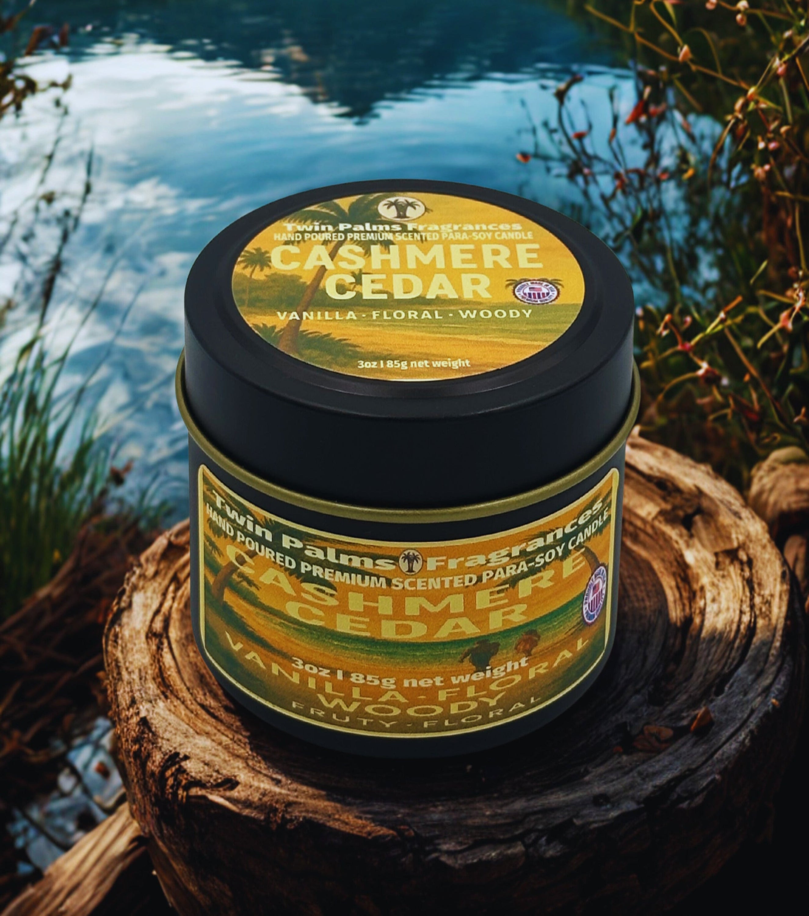 Twin Palms Fragrances Cashmere Cedar candle on a wooden log by a body of water