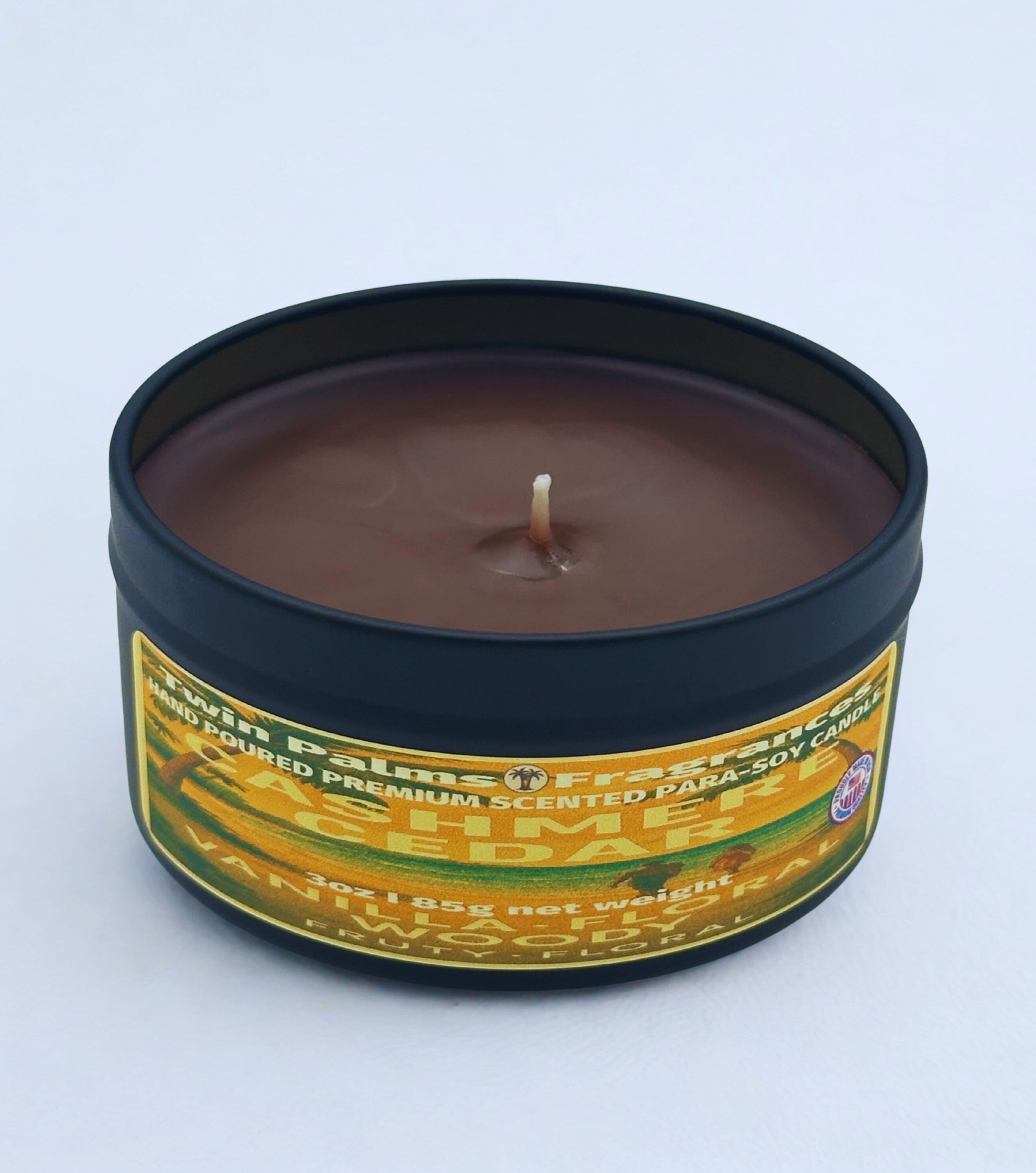 Twin Palms Fragrances Cashmere Cedar Candle in a tin with a label on a white background