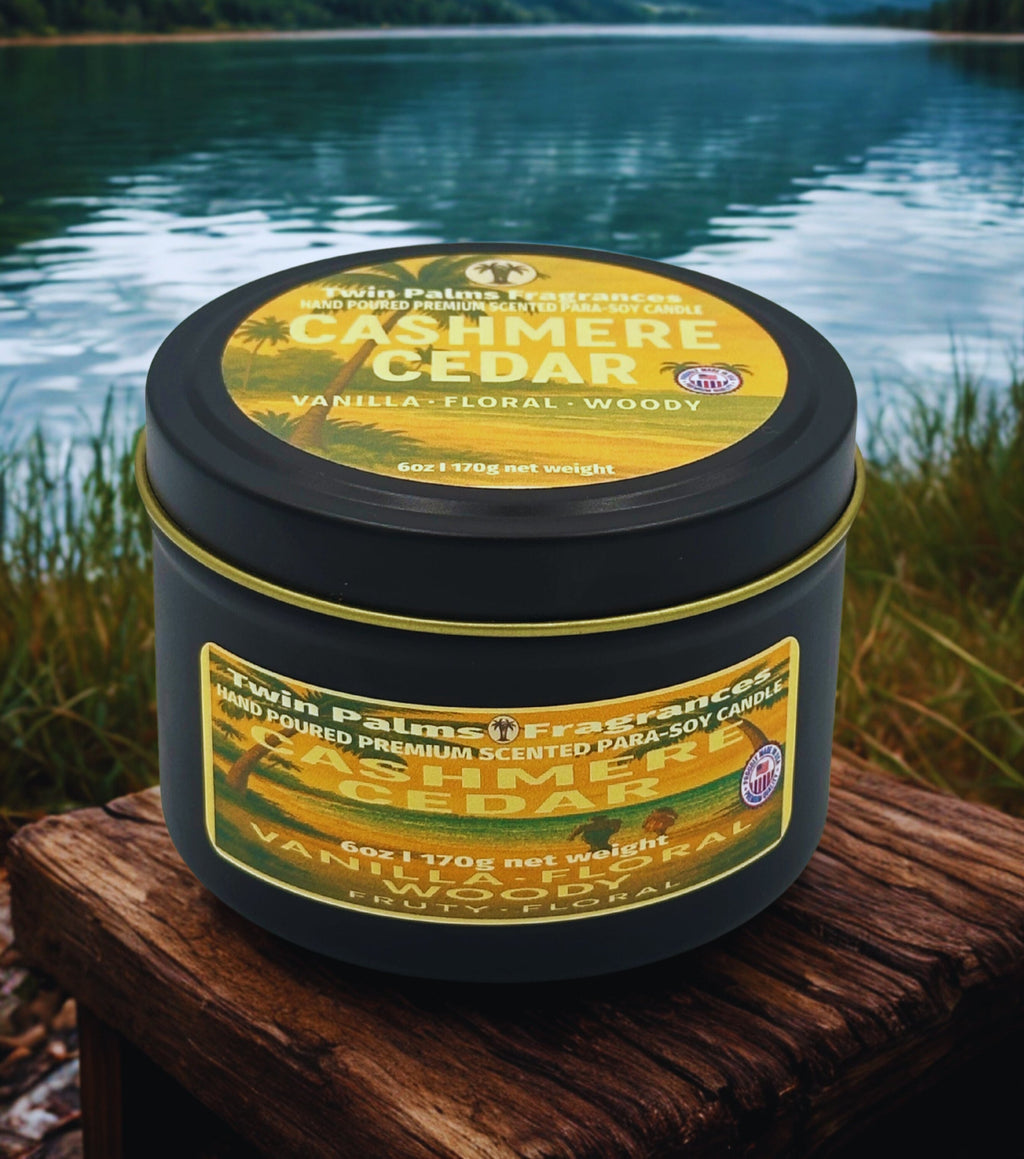 Twin Palms Fragrances Cashmere Cedar candle on a wooden surface with a lake background