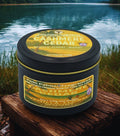 Twin Palms Fragrances Cashmere Cedar candle on a wooden surface with a lake background