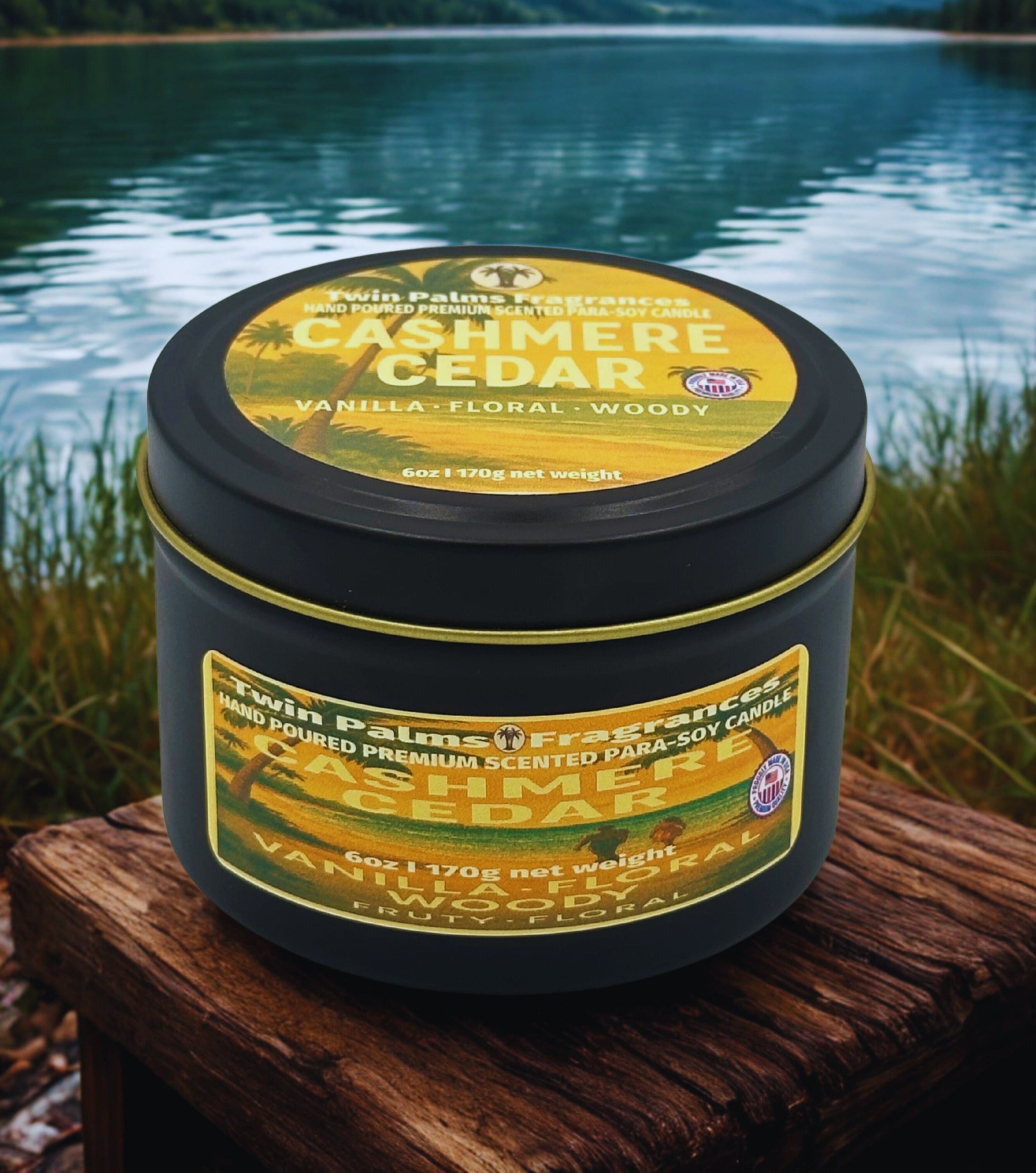 Twin Palms Fragrances Cashmere Cedar candle on a wooden surface with a lake background