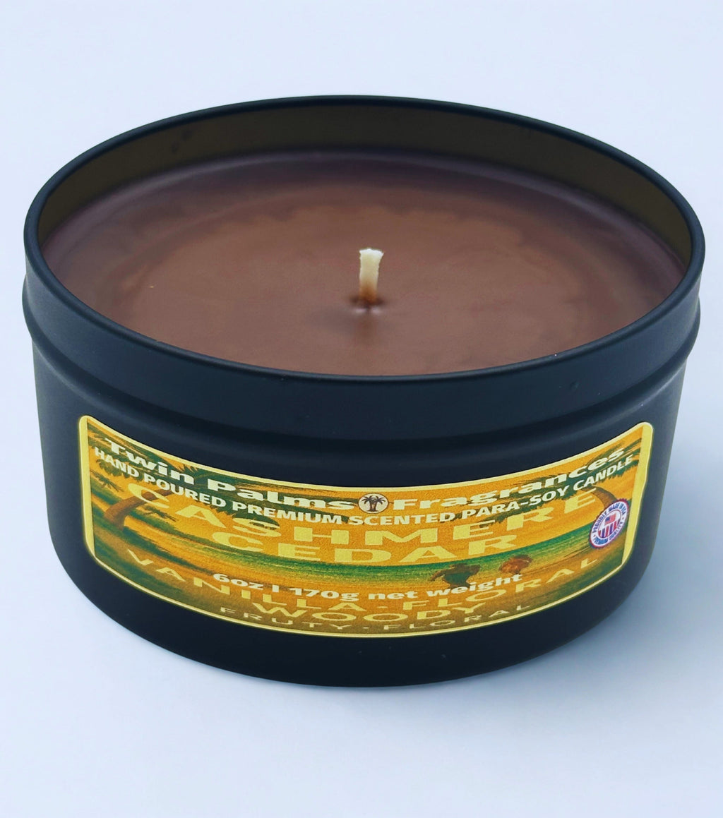 Twin Palms Fragrances Cashmere Cedar Candle in a tin with a label on a light blue background