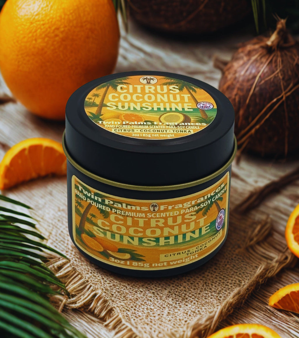 Twin Palms Fragrances tin  of 'Citrus Coconut Sunshine' candle with oranges and coconuts on a wooden surface