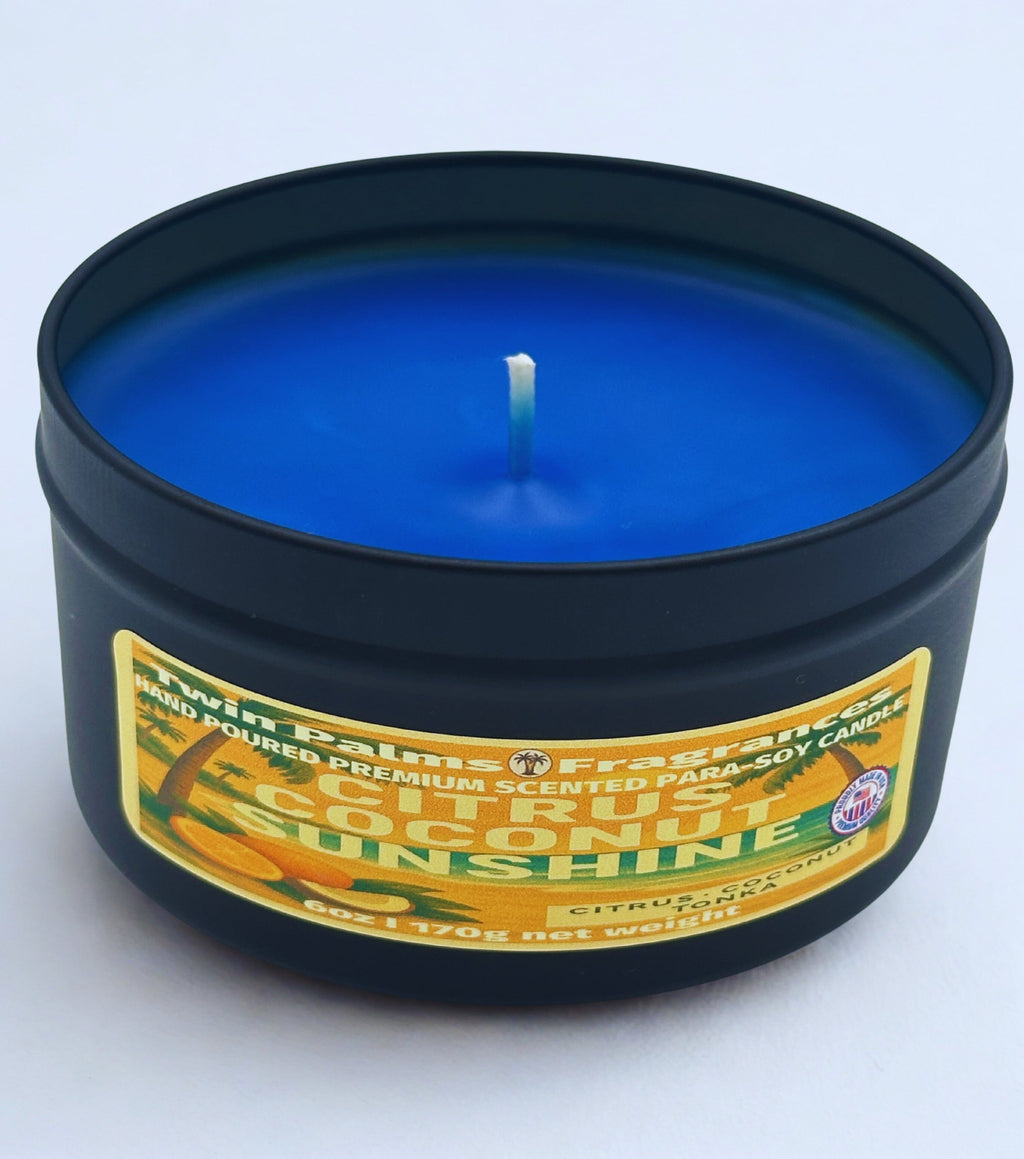 Blue candle in a black tin with a label on a white background