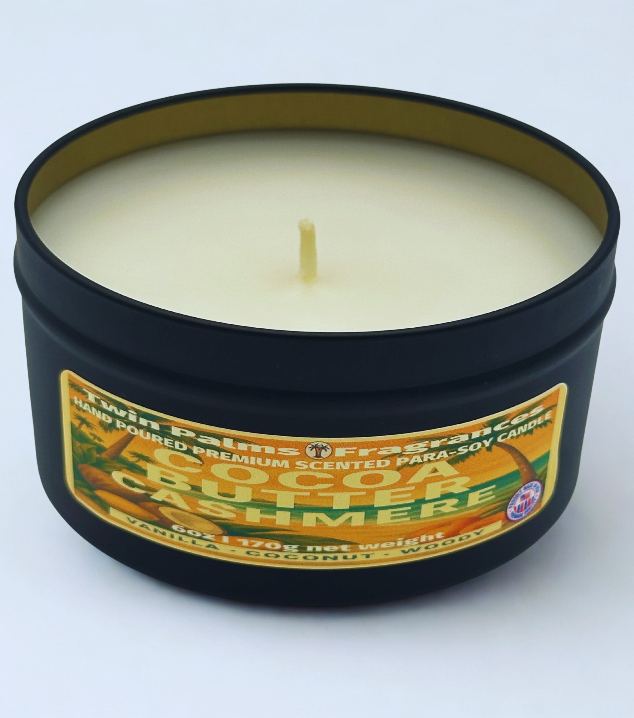 Twin Palms Fragrances Cocoa Butter Cashmere Candle in a black tin with a label on a white background