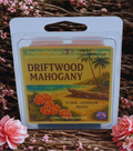 Twin Palms Fragrances Driftwood Mahogany wax melt packaging on a decorative background with flowers.