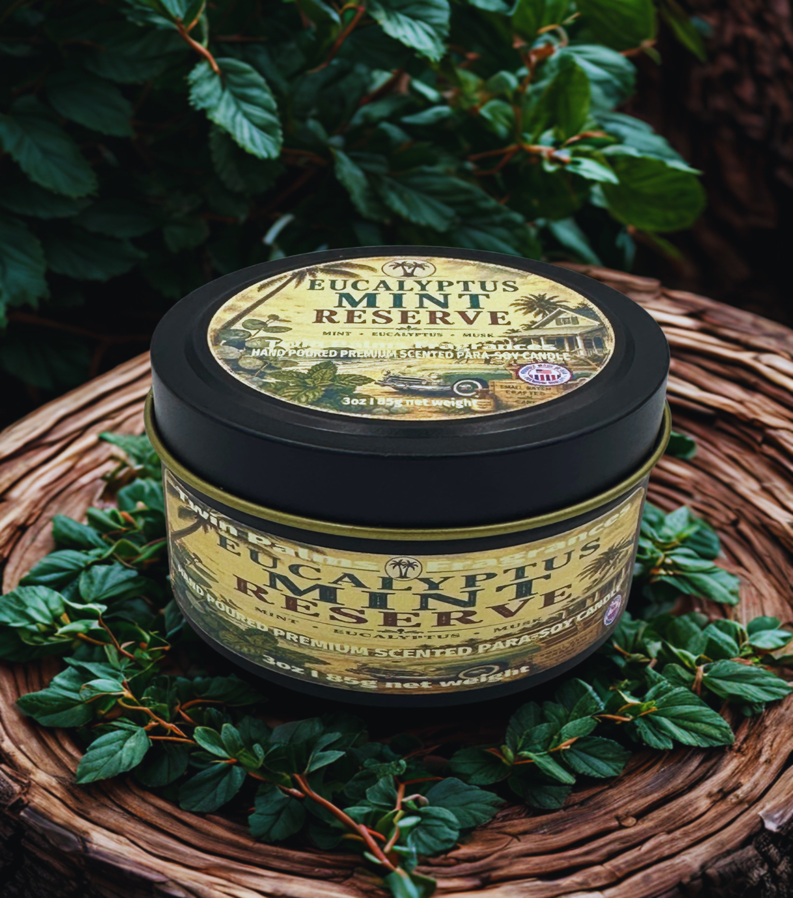 Twin Palms Fragrances Eucalyptus Mint Reserve candle tin on a woven surface with green leaves