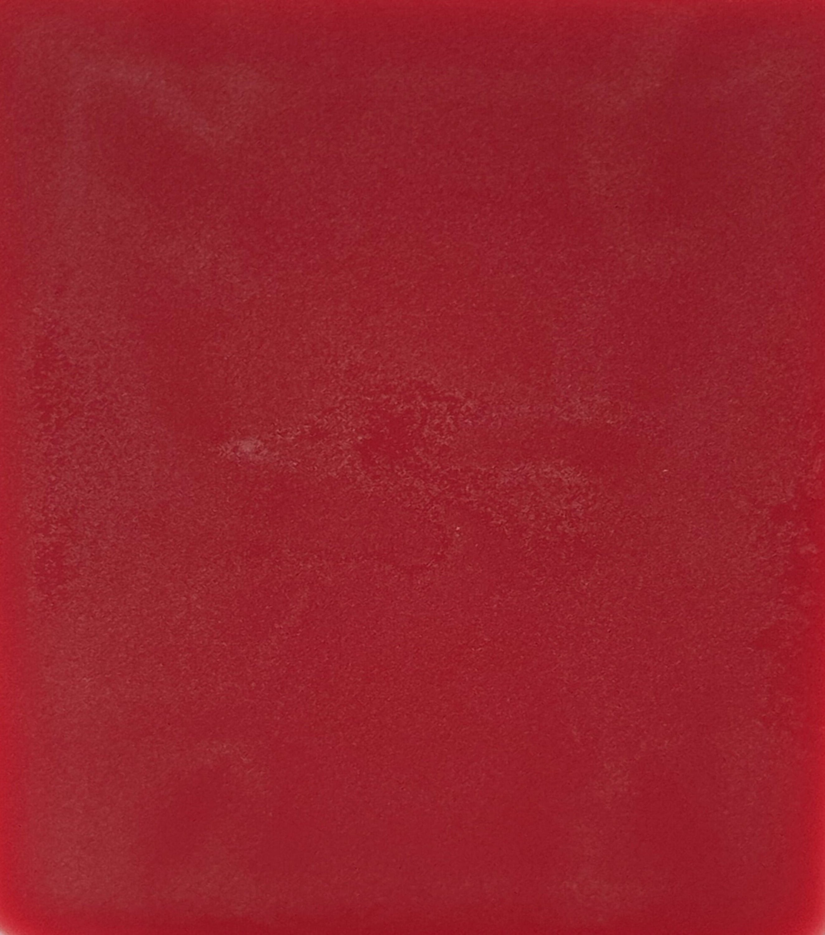 Solid red color swatch with a textured surface