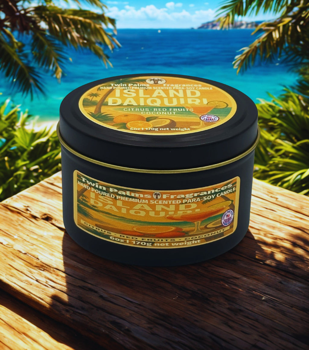 Twin Palms Fragrances candle tin labeled 'Island Daiquiri' on a wooden surface with a tropical background