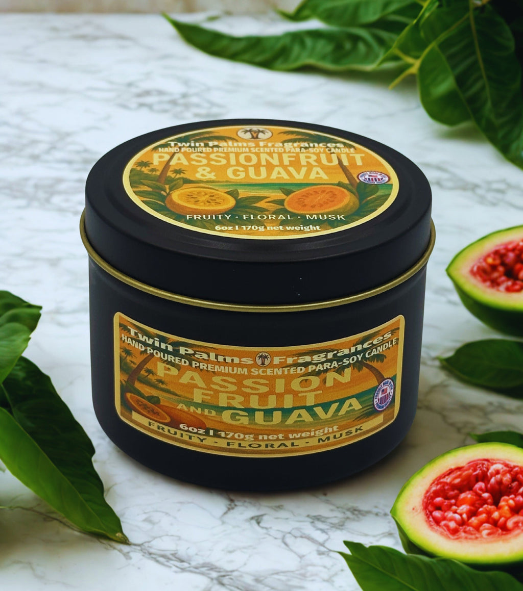 Twin Palms Fragrances candle tin with 'Passionfruit & Guava' fragrance on a marble surface with leaves and fruit slices.