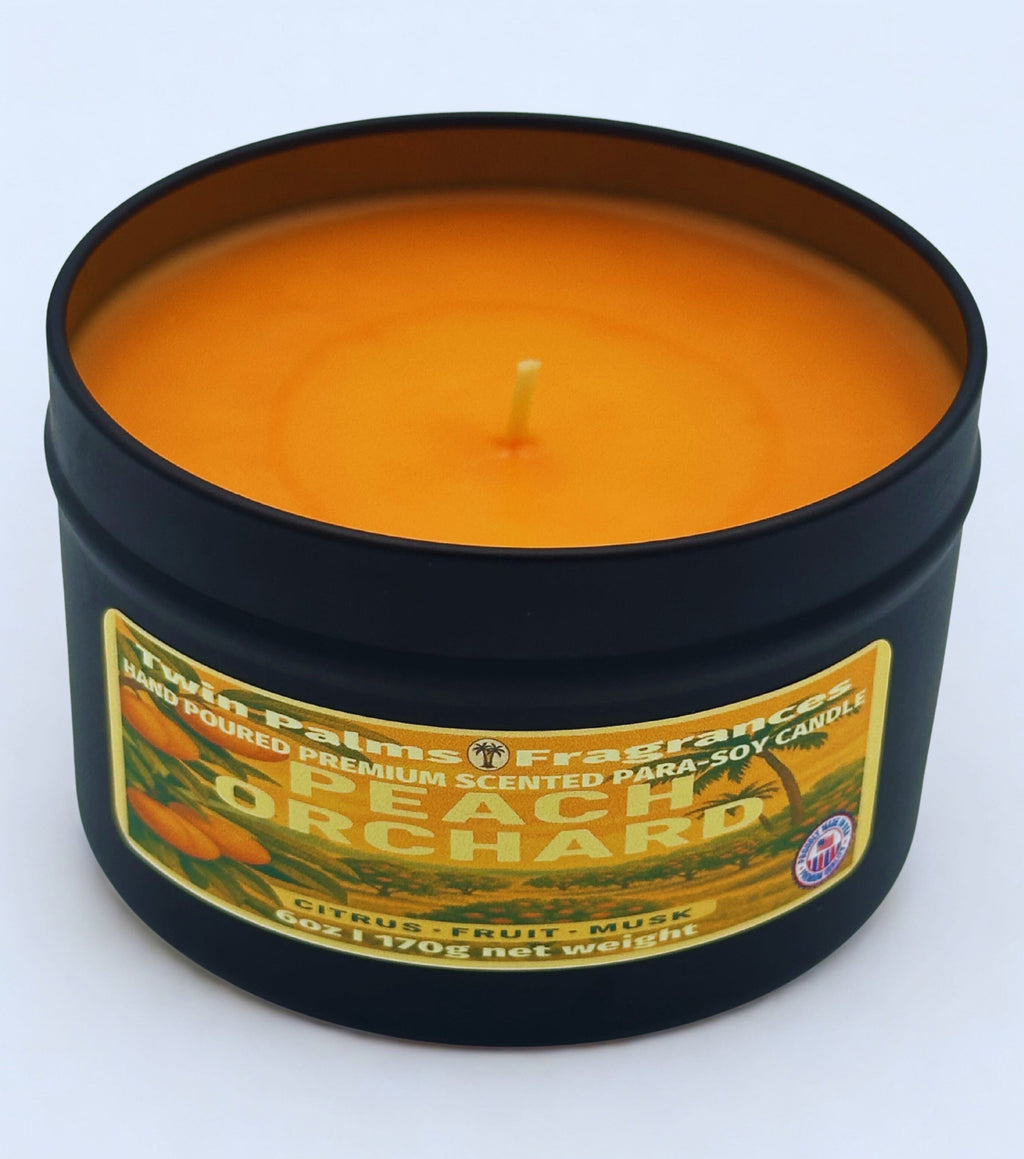 Candle in a tin labeled 'Peach Orchard' by Twin Palms Fragrances on a white background