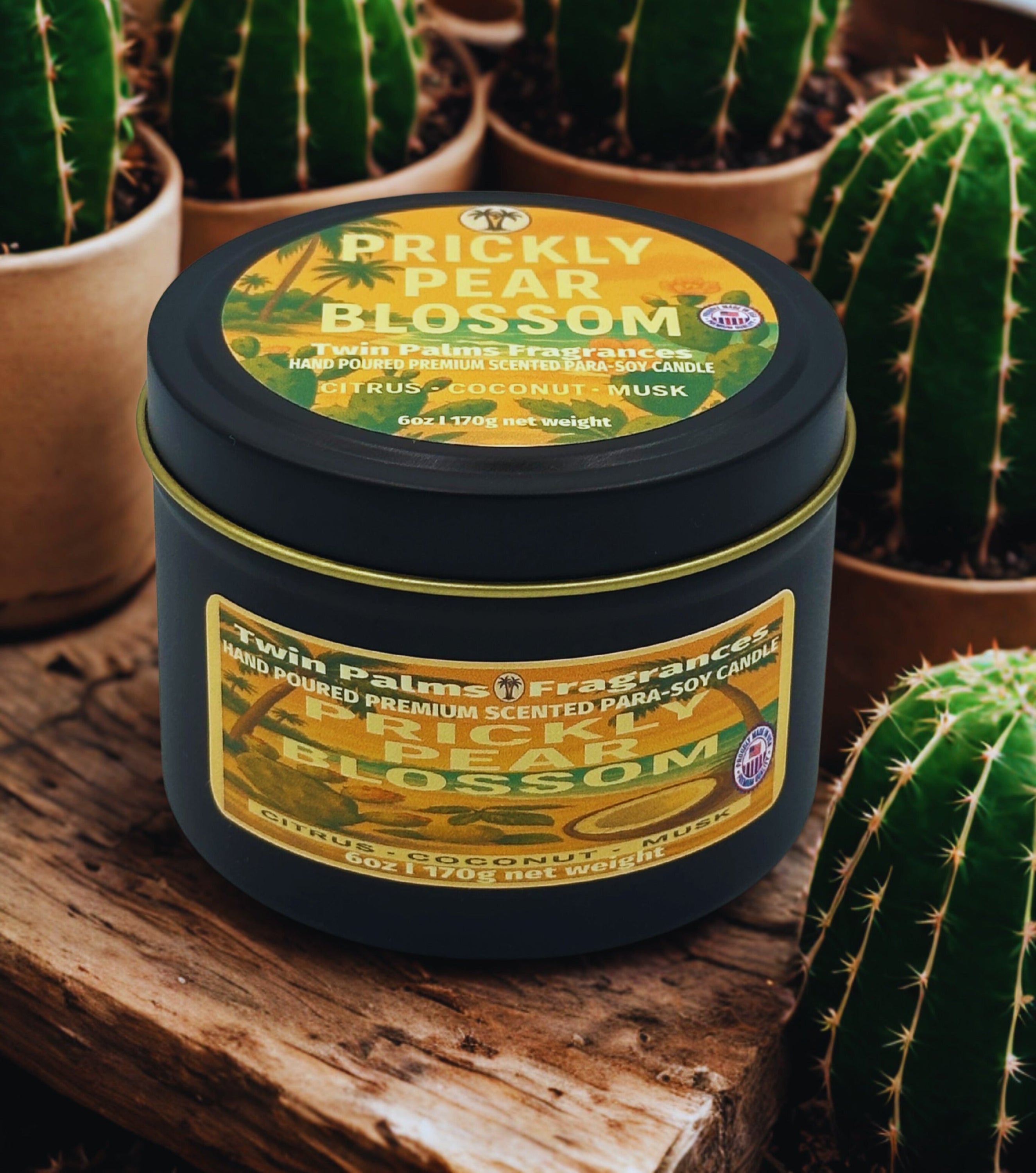Candle labeled 'Prickly Pear Blossom' by Twin Palms Fragrances with cacti in the background.