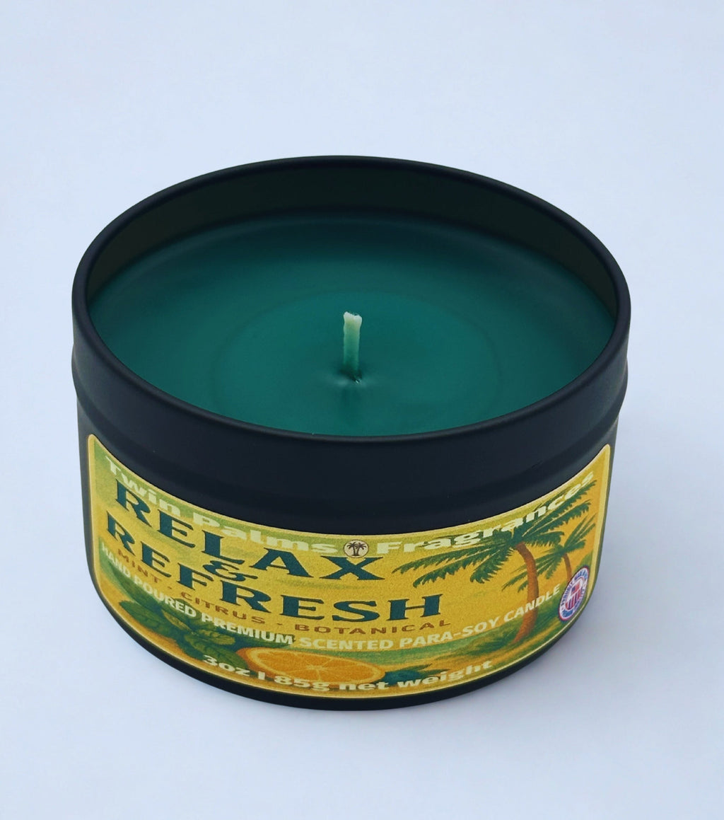 Twin Palms Fragrances candle in a tin labeled 'Relax & Refresh' on a light blue background