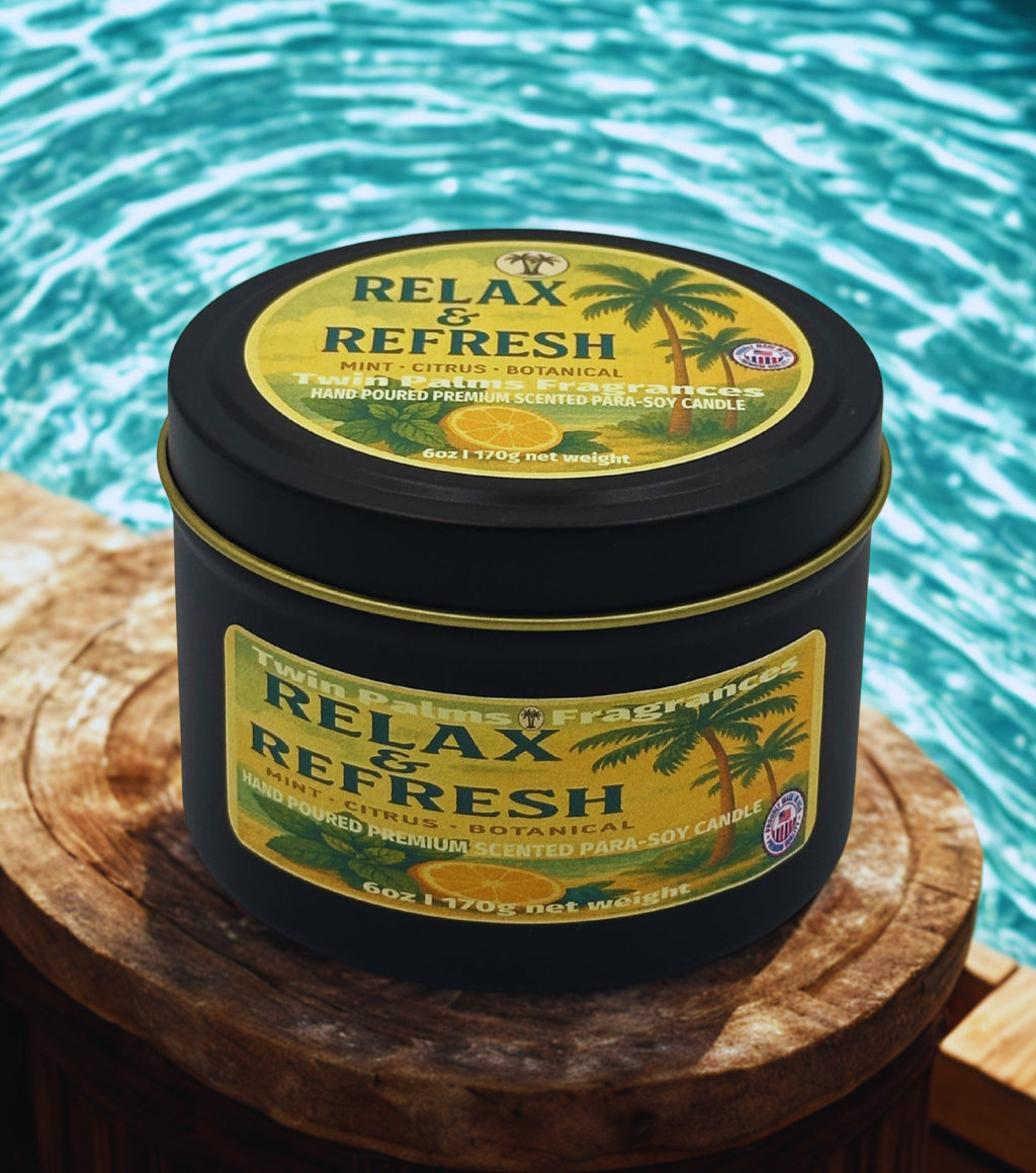 Tin of 'Relax & Refresh' candles on a wooden surface with a pool in the background