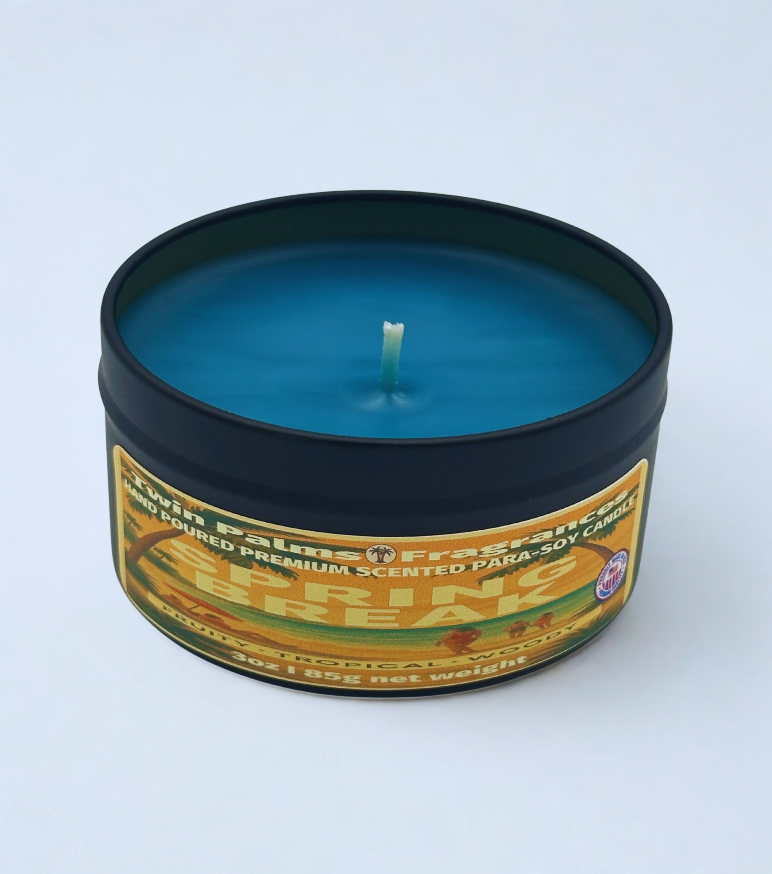 Blue candle in a tin with a label on a white background