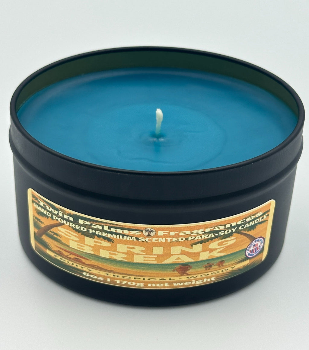 Twin Palms Fragrances blue candle in a black tin with a label Spring Break on a white background