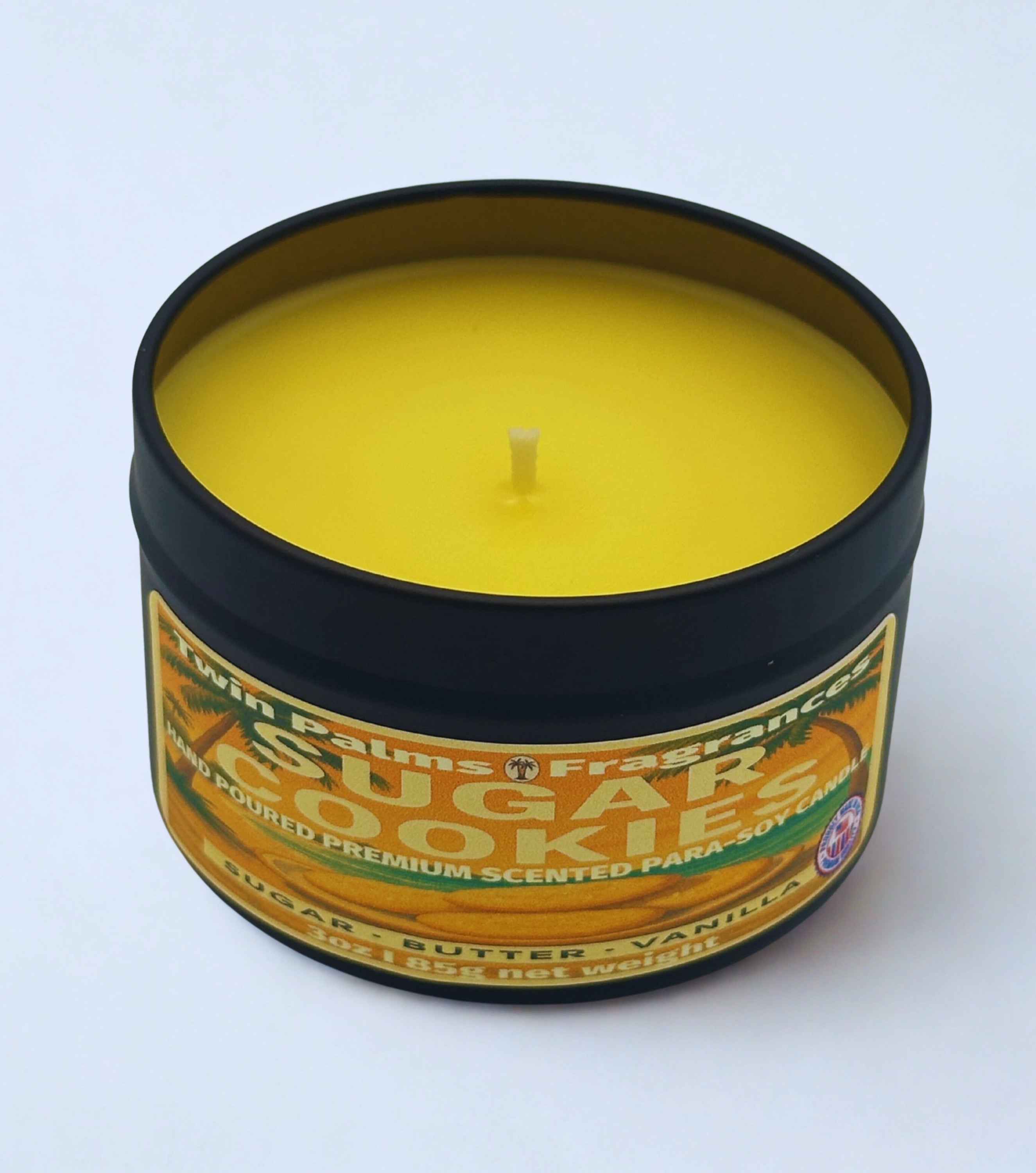 Candle in a tin labeled 'Sugar Cookies' by Twin Palms Fragrance on a white background