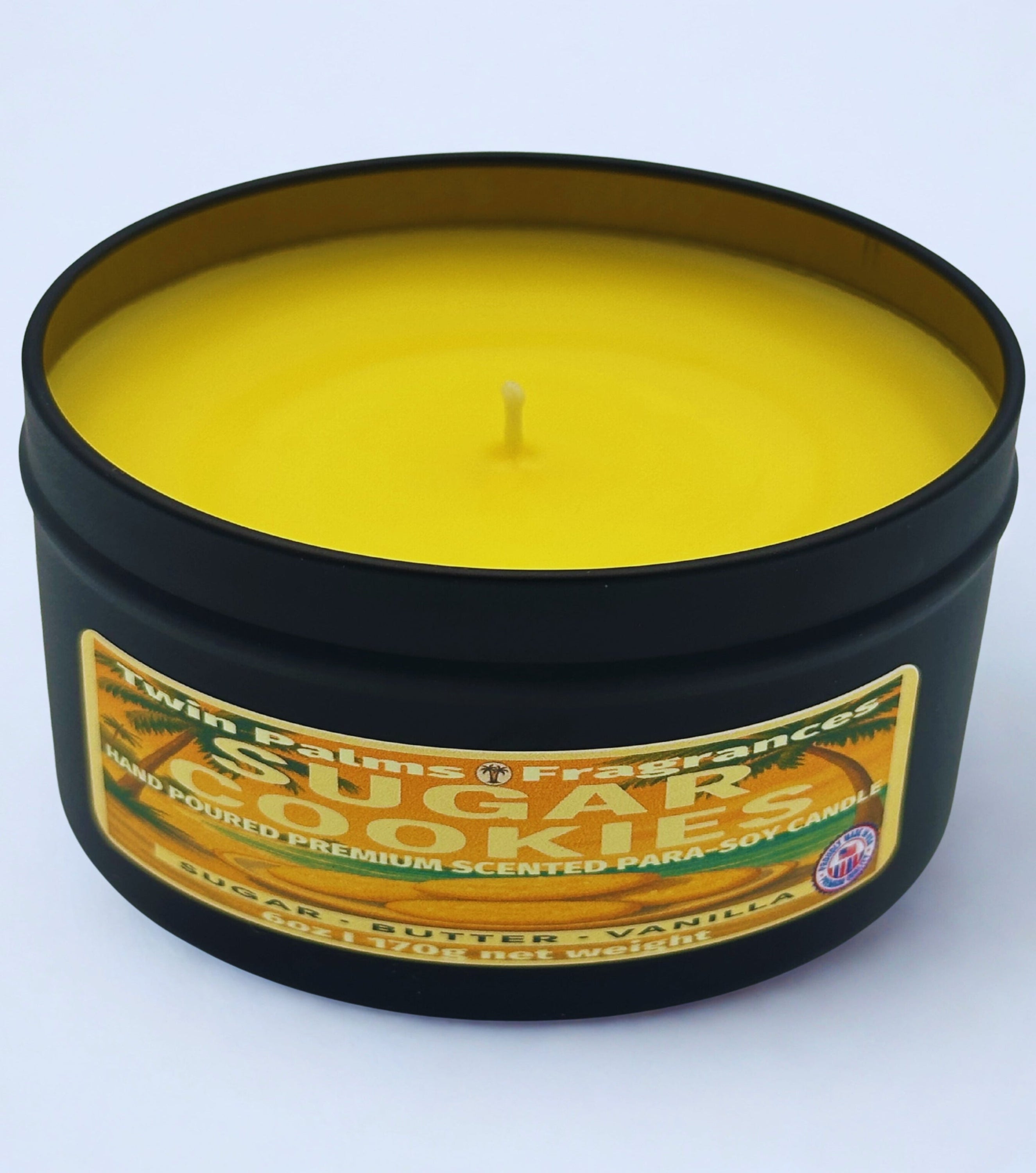 Candle in a black container with a label on a white background