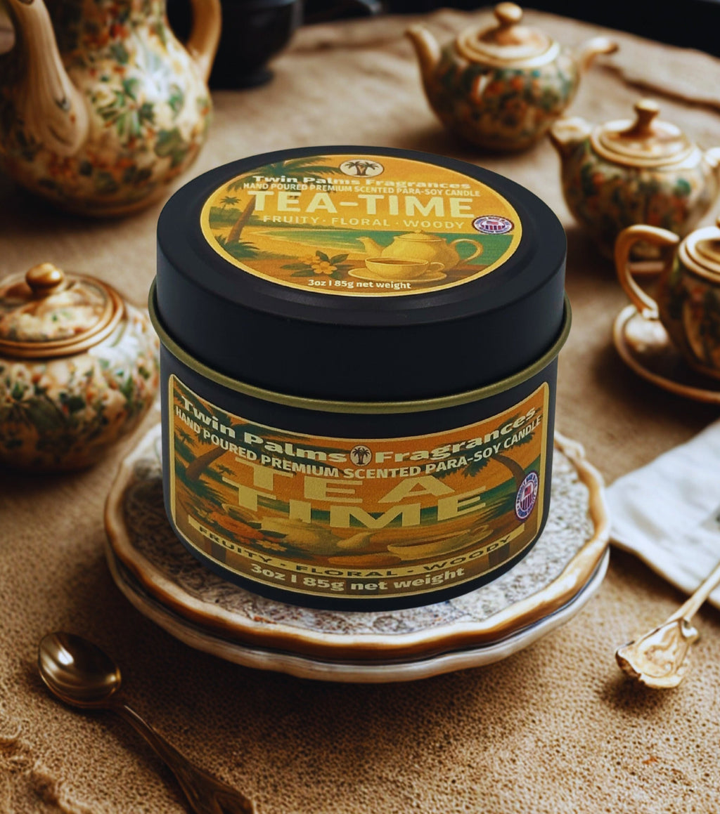 Twin Palms Fragrances Tea time scented candle in a decorative tin on a wooden surface with teapots.