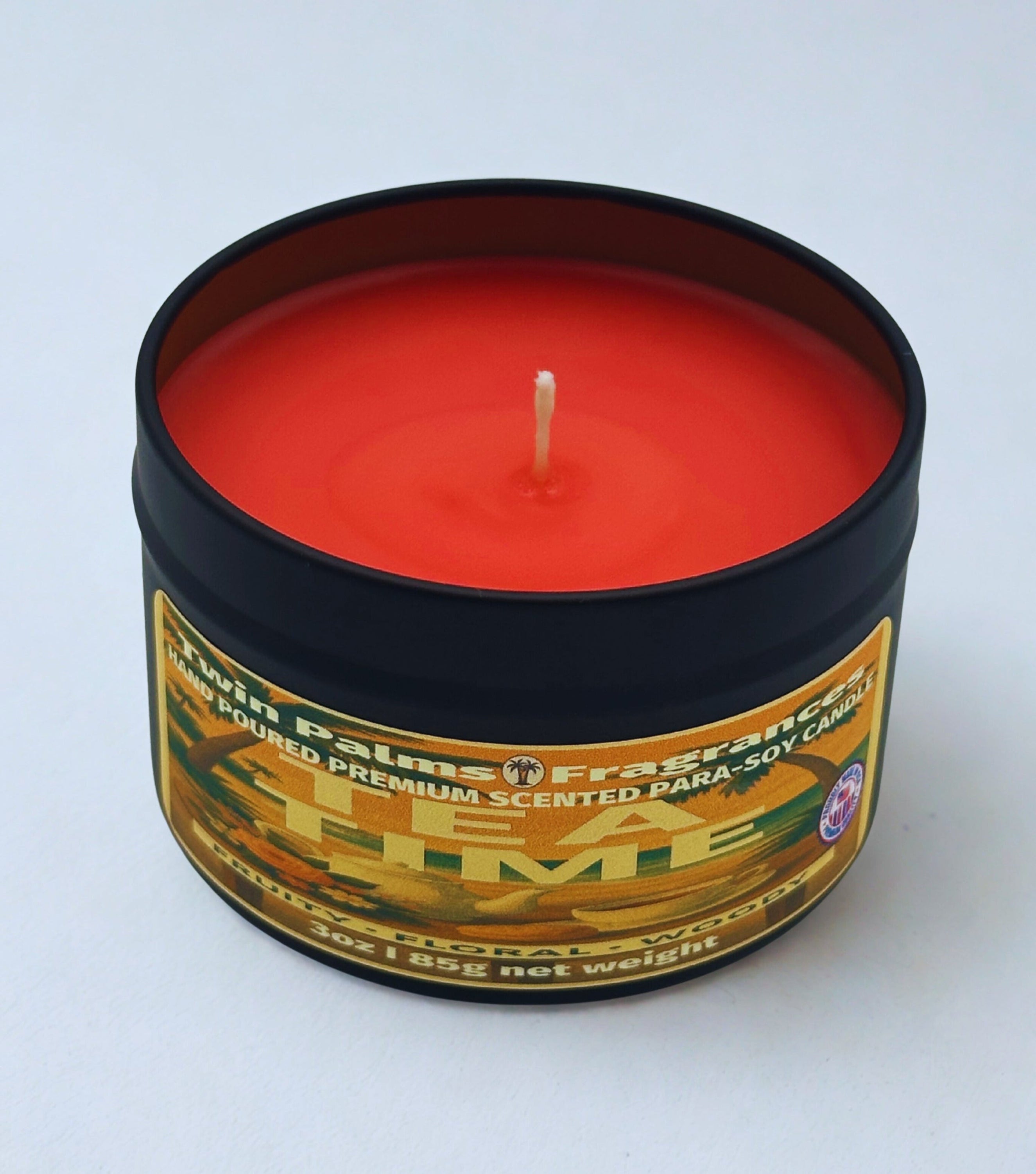 Twin Palms Fragrances candle in a tin with a label Tea Time on a white background
