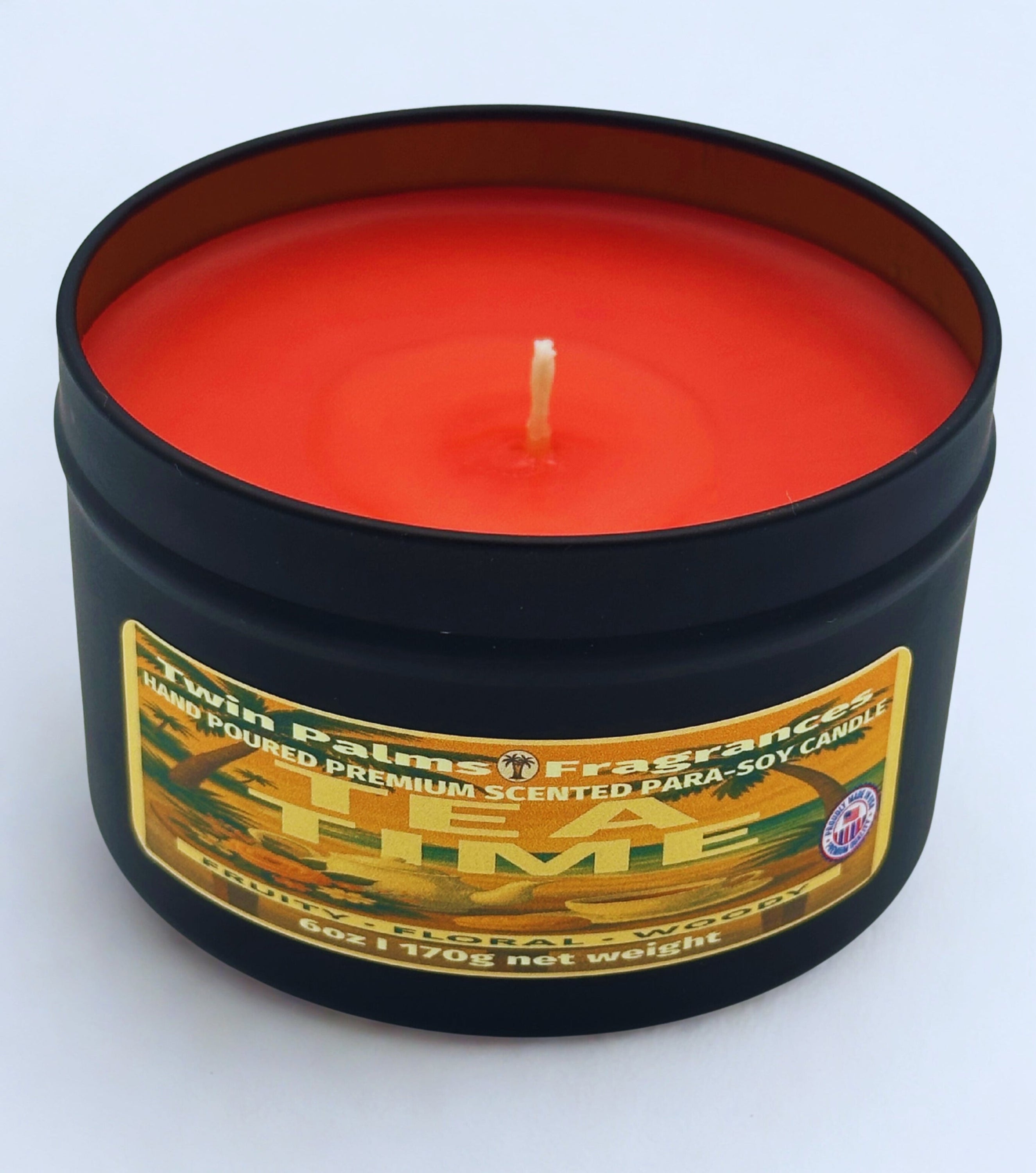 Twin palms Fragrances candle in a black tin with a label Tea Time  on a white background
