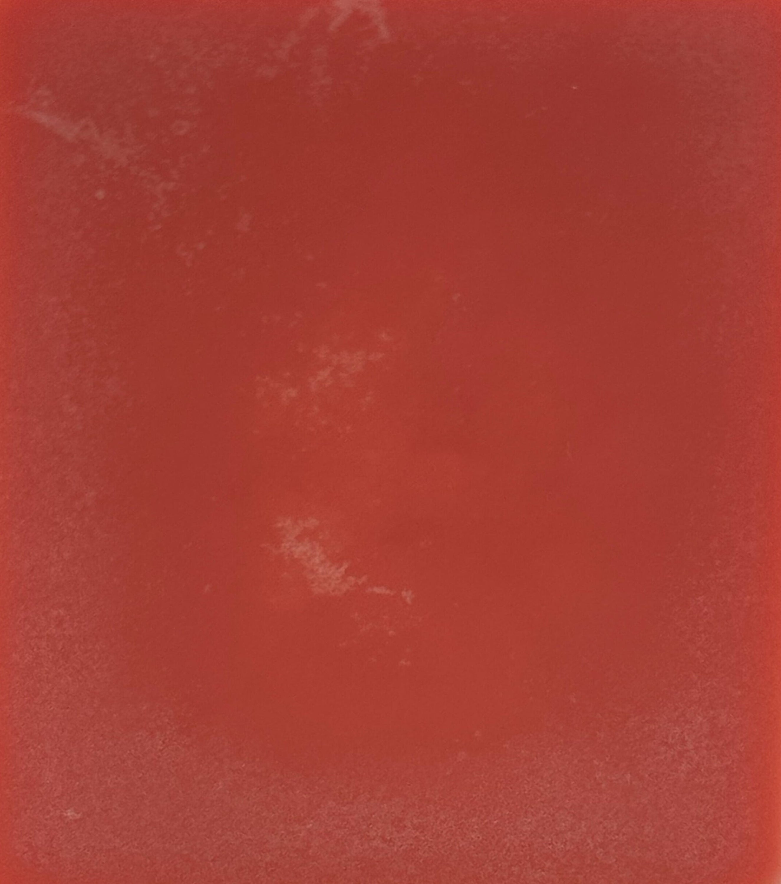 Solid red color swatch with a textured surface