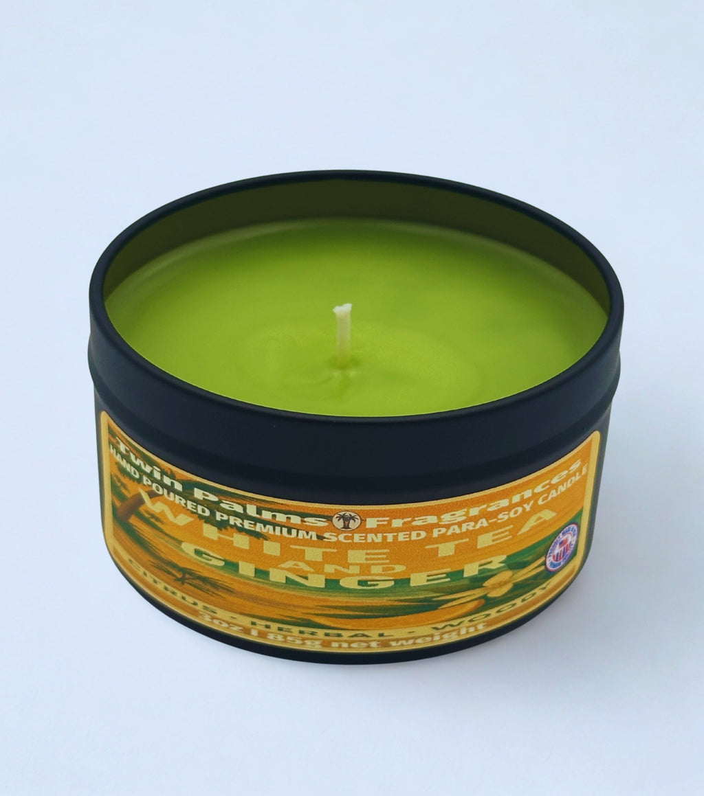 Candle in a tin labeled 'White Tea & Ginger' on a white background