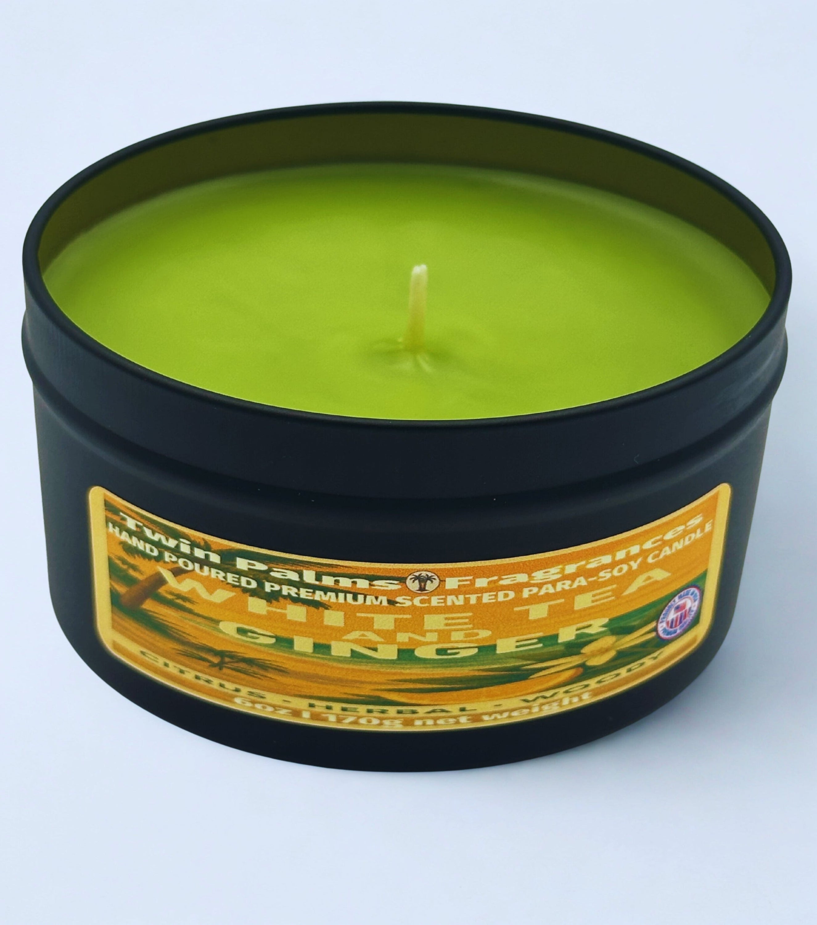 Candle in a tin container with a label on a white background