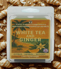 Twin Palms Fragrances soy wax melts packaging with 'White Tea and Ginger' scent on a wooden background.